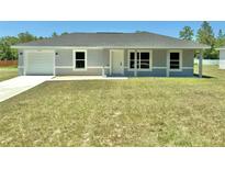 Charming single-story home featuring a well-maintained lawn and an attached one car garage at 14437 Sw 21St Pl, Ocala, FL 34481