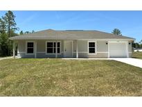 Charming single-story home with a well-manicured lawn and attached garage, perfect for suburban living at 14443 Sw 21St Pl, Ocala, FL 34481