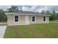 Charming single-story home featuring a new roof, fresh paint, and a well-maintained front yard at 20443 Sw Rainbow Lakes Blvd, Dunnellon, FL 34431