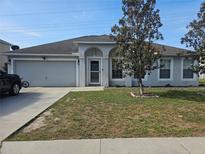 Charming single-story home featuring a two-car garage and inviting front yard with mature landscaping at 4520 Se 28Th St, Ocala, FL 34480