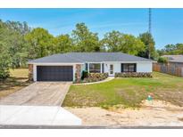 Charming single-story home with stone accents, well-maintained lawn, and attached garage at 6 Bahia Circle Loop, Ocala, FL 34472