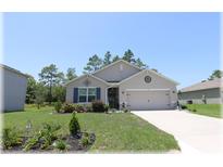 Charming single Gathering home with a well-maintained front yard and two car garage at 96 Hickory Crse, Ocala, FL 34472