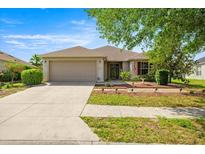 Charming single-story home featuring a two-car garage and a well-maintained front yard with manicured landscaping at 4225 Sw 57Th Ave, Ocala, FL 34474