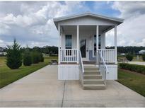 Charming single-story tiny home with a covered porch and manicured lawn at 4345 Nw 27Th Pl, Ocala, FL 34482