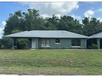 Charming single-story home featuring a well-maintained lawn, fresh landscaping and a newly painted exterior at 4911 Se 135Th Pl, Summerfield, FL 34491