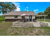 Charming single-story home features a covered carport, cozy front patio, and a manicured lawn at 531 Ne 142Nd Ave, Silver Springs, FL 34488