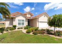 Charming single-story home with a terracotta tile roof and lush landscaping at 7210 Sw 179 Ct, Dunnellon, FL 34432