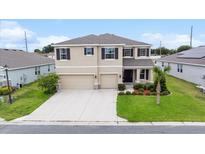 Two-story home showcasing manicured landscaping, a two-car garage, and an inviting front porch at 8110 Sw 59Th Ter, Ocala, FL 34476