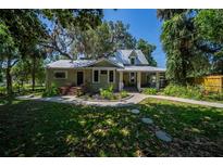 Charming home featuring a metal roof, landscaped yard, and inviting walkway at 20549 9Th St, Mc Intosh, FL 32664