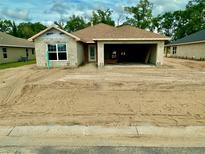 New construction shows the concrete block home with a front-entry two-car garage and completed roof at 3167 Ne 46Th Ave, Ocala, FL 34470