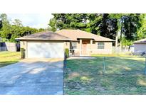 Charming single-story home featuring a well-maintained lawn, attached two car garage and a welcoming front entrance at 5263 Nw 62Nd Nw Ave, Ocala, FL 34482