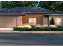 New construction home featuring a gray roof, wood style siding, an attached garage, and curb appeal landscaping at 7027 Sw 128 S, Ocala, FL 34473