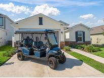 Inviting home featuring a golf cart and a well-manicured lawn at 7206 Sw 60Th Ln, Ocala, FL 34474