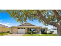 Charming single-story home featuring a well-maintained lawn and inviting front porch at 9750 Sw 97Th Pl, Ocala, FL 34481