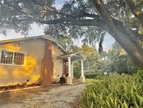 Charming home exterior featuring a quaint porch with white columns and a well-maintained landscaped front yard at 3005 Ne 19Th Ave, Ocala, FL 34479