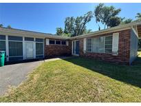 Charming single story home with red brick and a well-manicured lawn on a sunny day at 4000 Sw 6Th Ave, Ocala, FL 34471