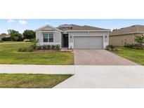 Charming single-story home with a two-car garage and a well-maintained lawn at 4892 Nw 39Th Loop, Ocala, FL 34482