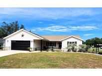 Charming single-story home with a well-manicured lawn and attached garage at 6312 Sw 60Th Ct, Ocala, FL 34474
