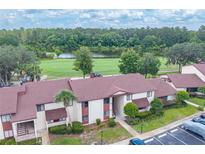 Scenic aerial view showcasing the community, lush greenery, and a beautiful serene lake at 688 Midway Dr # B, Ocala, FL 34472