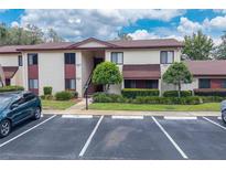 Attractive two-story condo with a parking lot, a walkway and landscaping in a well-maintained community at 688 Midway Dr # B, Ocala, FL 34472