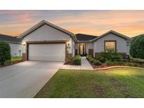 Charming single-story home featuring a 2-car garage, manicured lawn, and welcoming front entrance at 7263 Sw 99Th Cir, Ocala, FL 34481