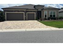 Charming single-story home featuring a two-car garage, stone accents, paver driveway, and well-maintained landscaping at 9394 Sw 60Th Lane Rd, Ocala, FL 34481