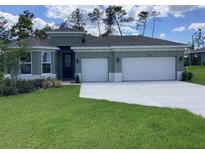 Charming single-story home with well-manicured lawn and a three-car garage on a sunny day at 10540 Sw 49Th Avenue Rd, Ocala, FL 34476