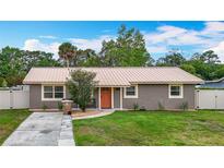Charming home has a metal roof, lush lawn, and inviting curb appeal at 1520 Ne 17Th Ave, Ocala, FL 34470