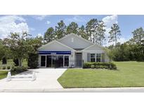 Charming single-story home with well-manicured lawn, tasteful landscaping and inviting storefront style front entrance at 24 Hickory Crse, Ocala, FL 34472