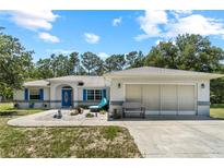 Charming single-Gathering home features a well-manicured front yard and a two-car garage at 2698 Sw 186Th Ct, Dunnellon, FL 34432