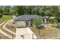Charming single-story home featuring a well-manicured lawn and attached one car garage at 361 Oak Lane Drive Dr, Ocala, FL 34472