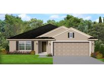 Charming single-story home with a two-car garage, black shingle roof, and well-manicured lawn at 4643 Ne 32Nd Pl, Ocala, FL 34470