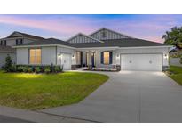 Charming single-Gathering home with a well-manicured lawn, a two-car garage, and stone column accents at 7638 Sw 60Th St, Ocala, FL 34474