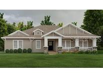 Charming single-story home featuring stone accents, covered porch, and well-manicured front lawn at 8290 Nw 17Th Cir, Ocala, FL 34475