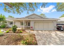 Charming single-story home with a brick facade, covered porch, and beautifully landscaped front yard at 8998 Sw 94Th St # D, Ocala, FL 34481