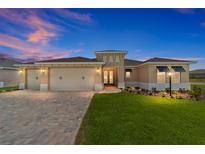 Charming single-story home showcasing a lush lawn, brick driveway, and a three-car garage at 9813 Sw 105Th Ct, Ocala, FL 34481