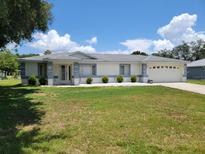 Charming single story home with a well-manicured lawn and neatly trimmed shrubs at 10269 Sw 63Rd Ave, Ocala, FL 34476