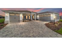 Charming two-car garage home with stone driveway, manicured garden, and welcoming curb appeal at 10553 Sw 98Th Pl, Ocala, FL 34481
