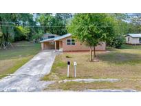 Charming single-story home with a covered carport and a well-maintained lawn at 1322 Ne 53Rd St, Ocala, FL 34479