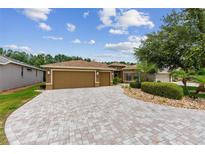 Beautiful single-story home featuring a three-car garage and meticulously landscaped front yard at 1429 Sw 160Th Ln, Ocala, FL 34473