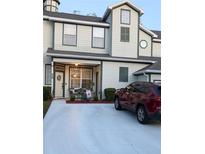 Charming two-story townhouse with a manicured lawn and a welcoming front porch at 231 Ne 28Th Ave # 207, Ocala, FL 34470