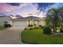 Charming single-story home with a well-manicured lawn and a welcoming two-car garage at 3141 Roswell Rd, The Villages, FL 32162