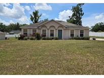 Charming single-story home with a well-manicured lawn, lush landscaping, and a welcoming front entrance at 4460 Sw 44Th St, Ocala, FL 34474