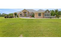 Stunning single-story home with a well-manicured lawn and stone accents at 6573 S Magnolia Ave, Ocala, FL 34471