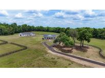 Expansive ranch estate featuring lush pastures, mature trees, and a secondary building for flexible living or storage at 1631 W Hwy 329, Citra, FL 32113