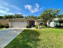 Charming one-story home features a two-car garage, manicured lawn, and beautiful landscaping at 16405 Sw 14Th Avenue Rd, Ocala, FL 34473