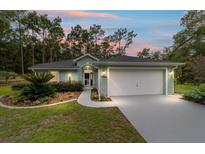 Charming home featuring landscaped front yard and two-car garage, perfect for suburban living at 19028 Sw 101 Pl, Dunnellon, FL 34432