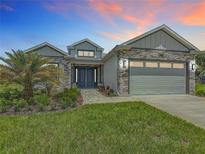 Beautiful single-Gathering home with stone accents, well-maintained landscaping, and a two-car garage at 4370 County Road 121D, Wildwood, FL 34785