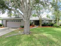 Charming single-story home featuring a well-maintained lawn, mature trees, and inviting curb appeal at 5083 Se 26Th St, Ocala, FL 34480
