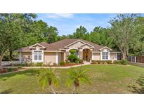Charming single-story home featuring a well-manicured lawn, mature landscaping, and inviting curb appeal at 5174 Se 41St Ave, Ocala, FL 34480